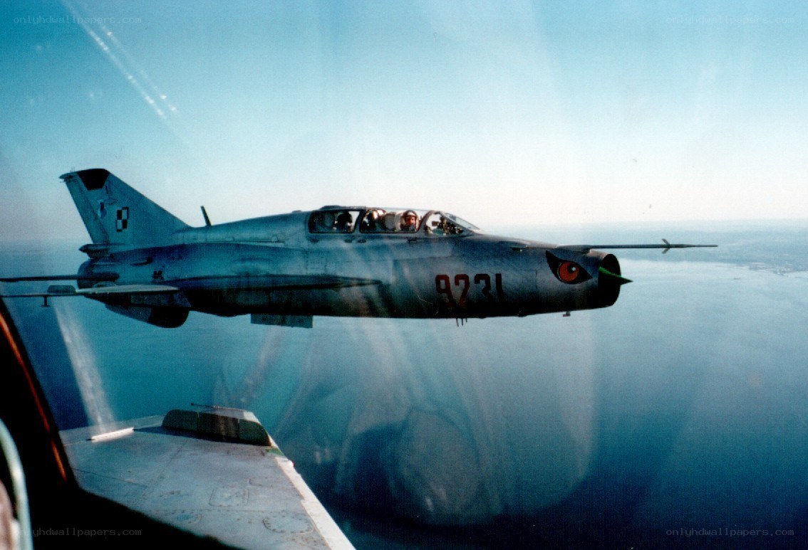 MiG-21 in flight over water