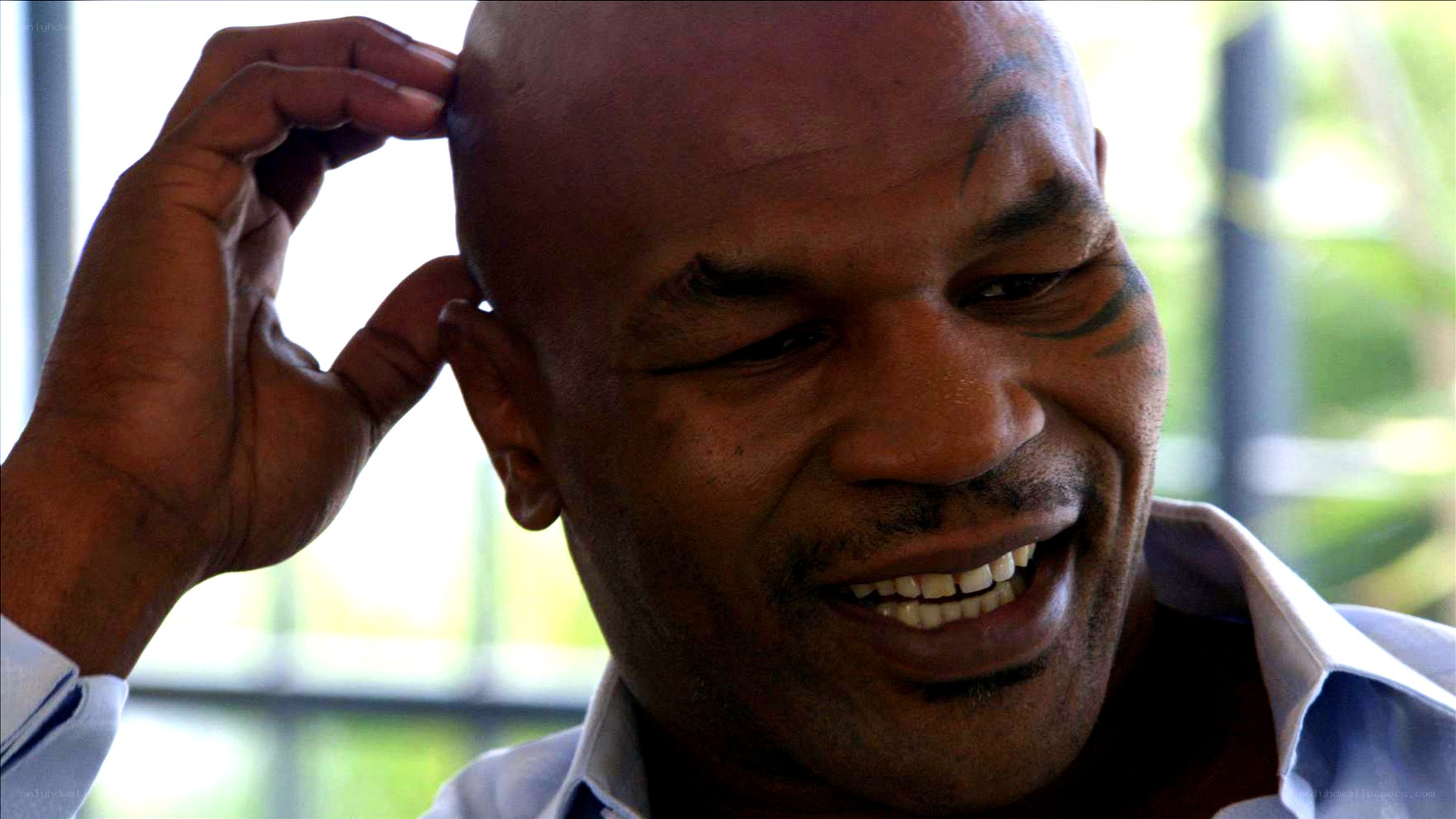 Mike Tyson smiling and touching head
