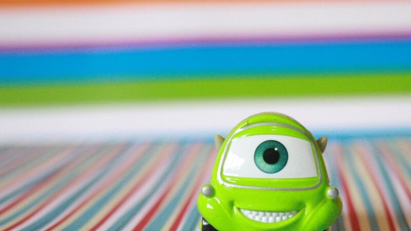 Mike Wazowski toy on colorful background