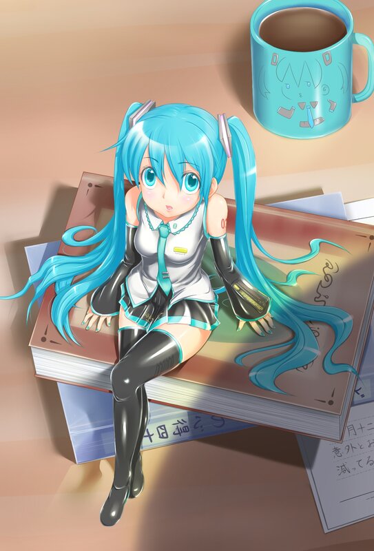 Miku sitting on books