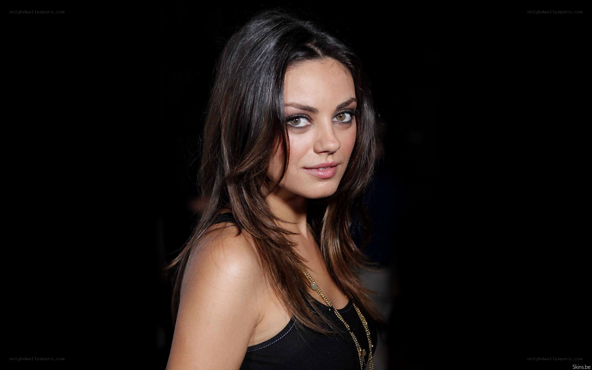 Mila Kunis in a black top