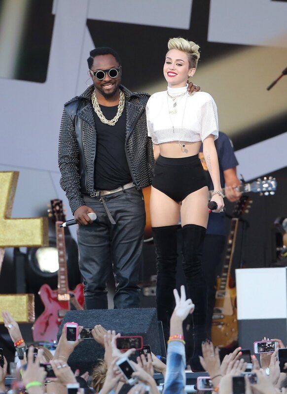 Miley Cyrus and a musician on stage