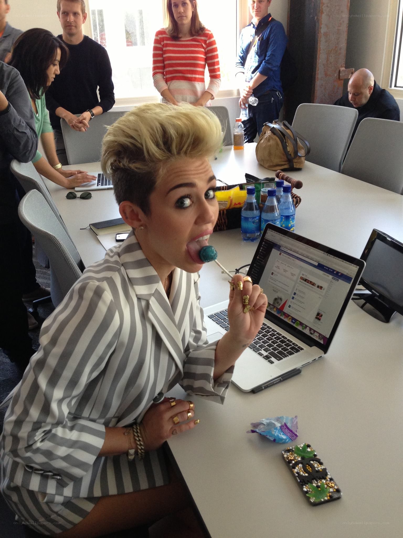 Miley Cyrus eating a lollipop