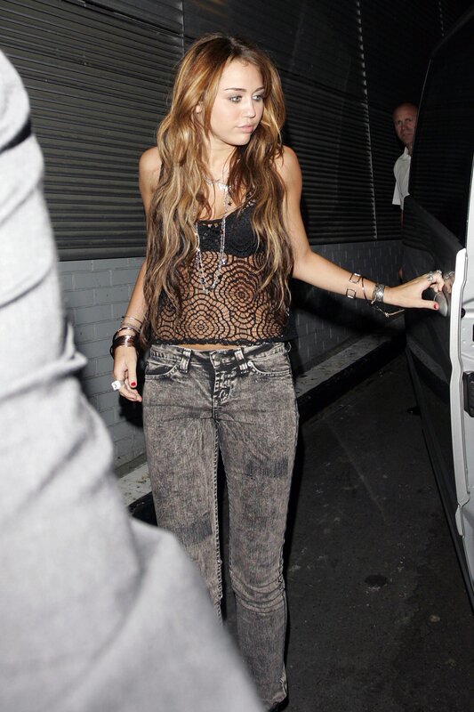 Miley Cyrus exiting a vehicle