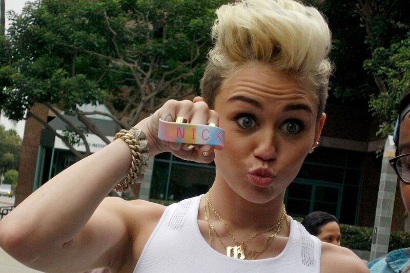 Miley Cyrus holding a wristband