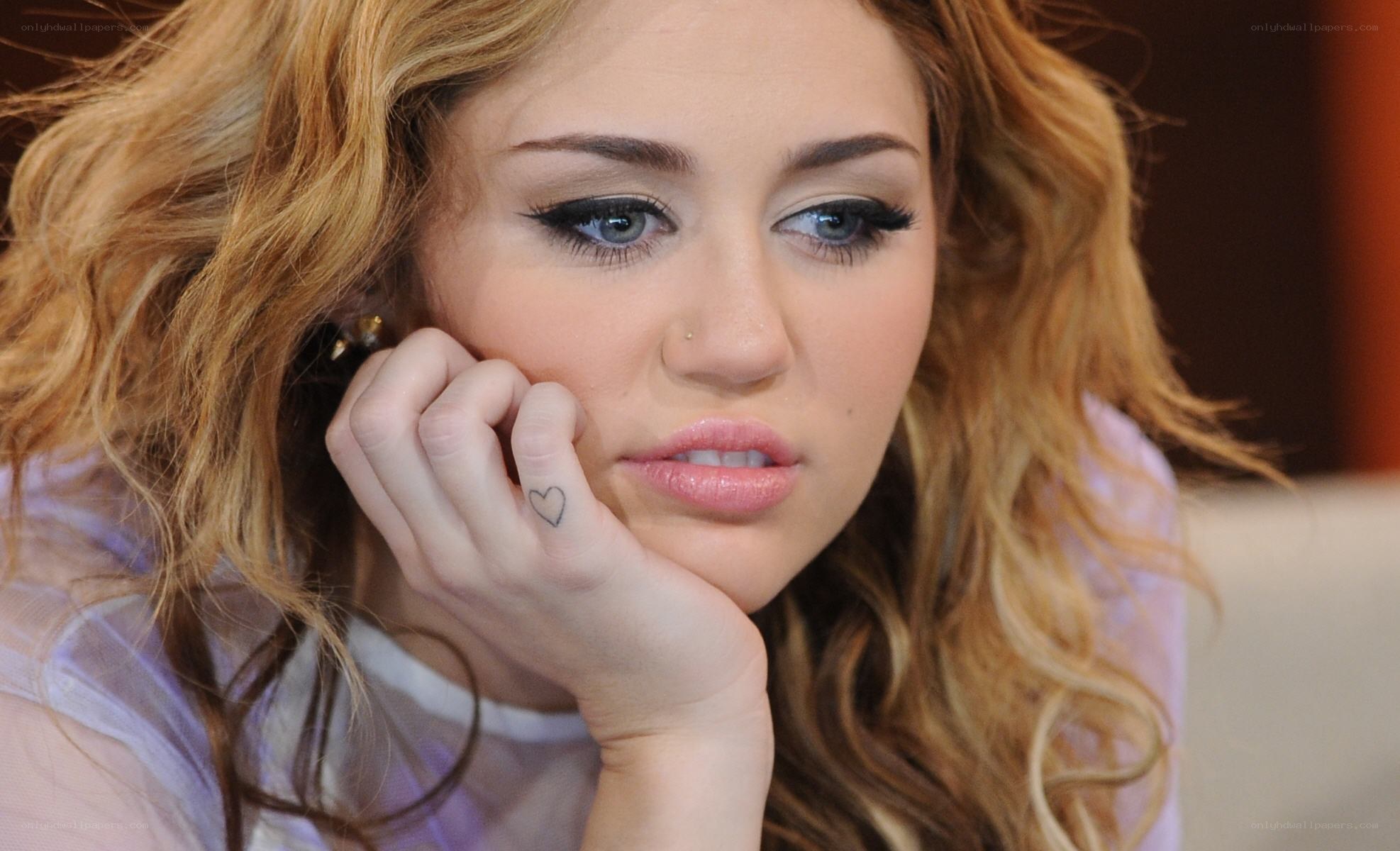 Miley Cyrus with heart tattoo