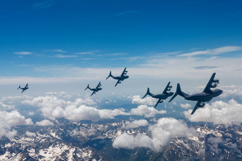 Military aircraft flying over mountains
