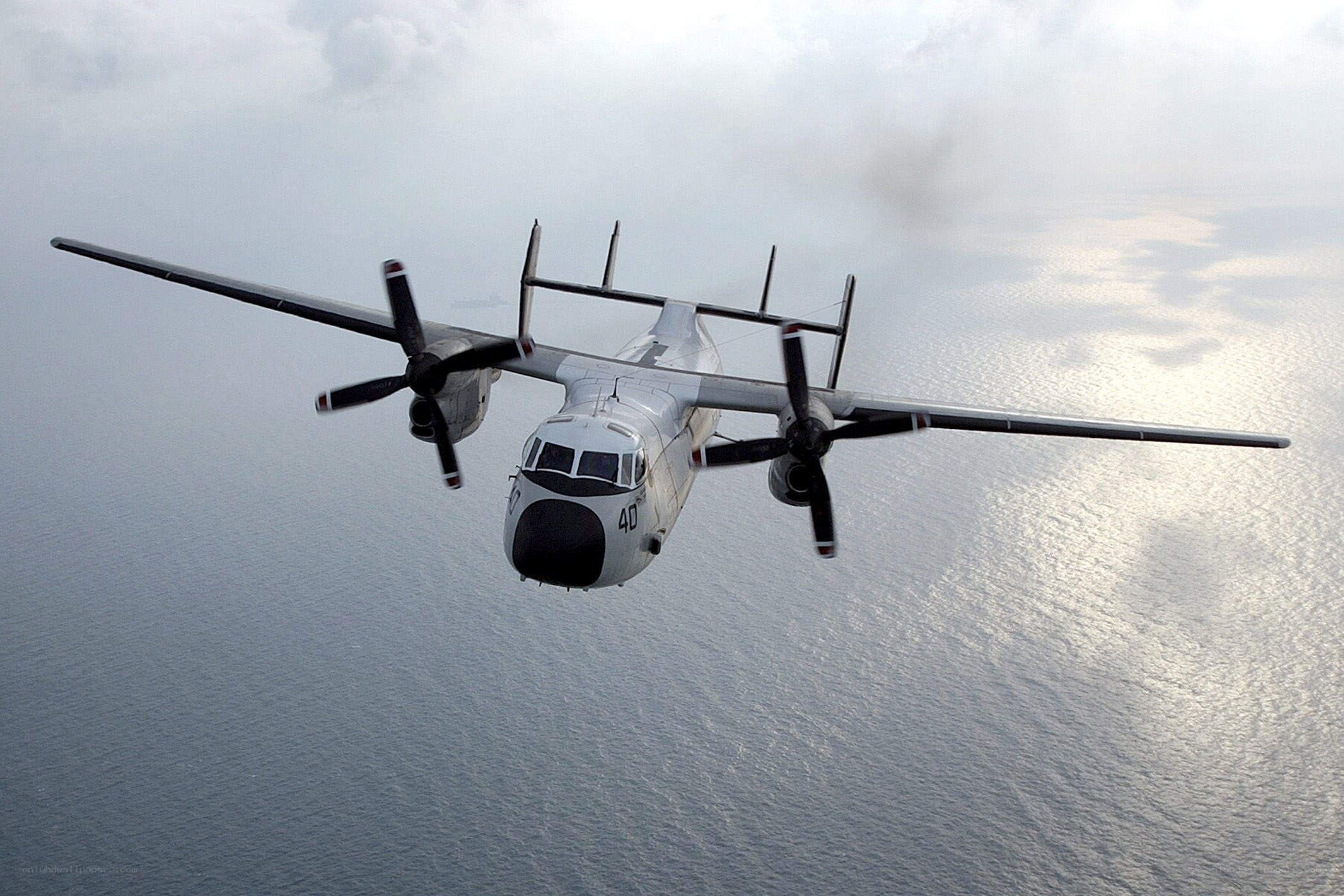 military aircraft flying over ocean