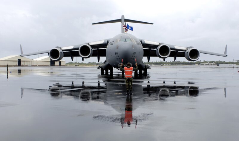 Military aircraft on wet tarmac