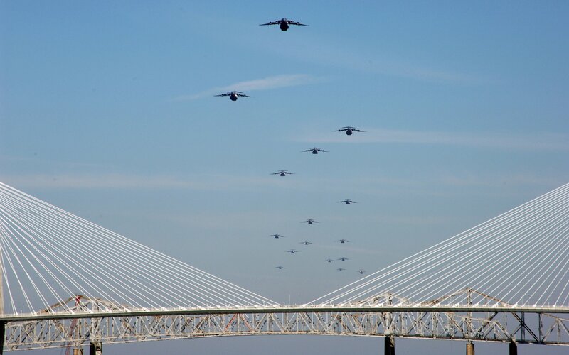 Military aircraft over a bridge