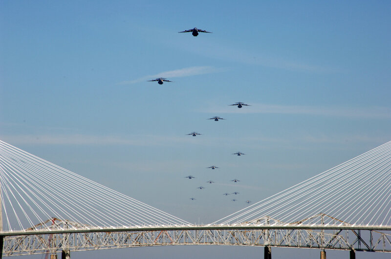 Military aircraft over a bridge