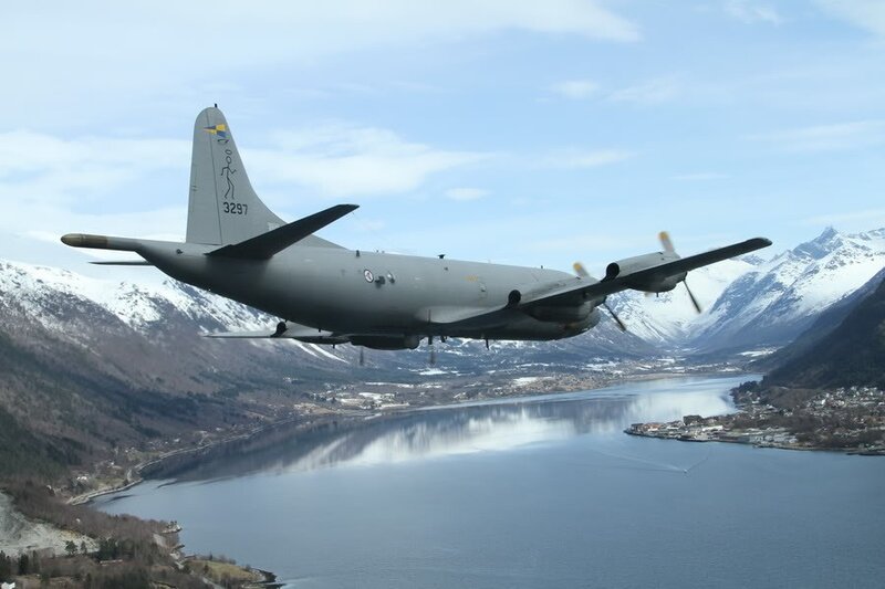 Military aircraft over fjord