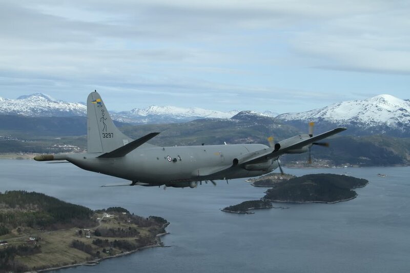 Military aircraft over fjord