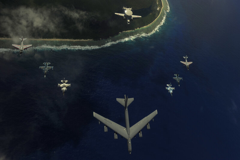 Military aircraft over island