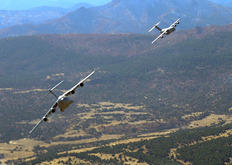 Military aircraft over mountainous terrain
