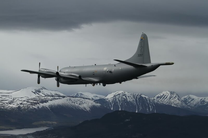 military aircraft over snowy mountains