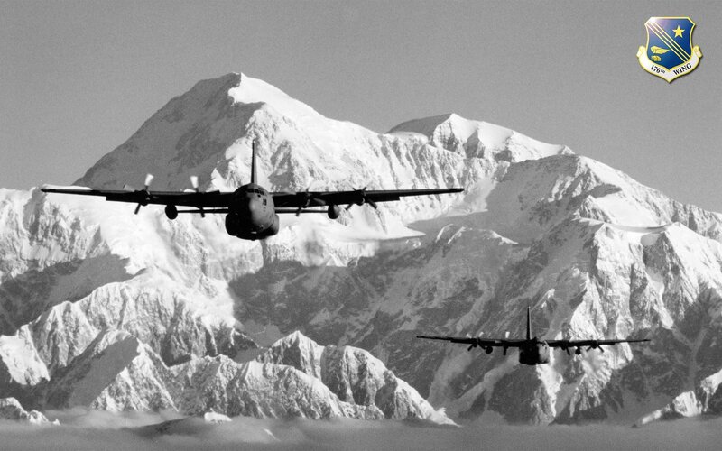 Military aircraft over snowy mountains