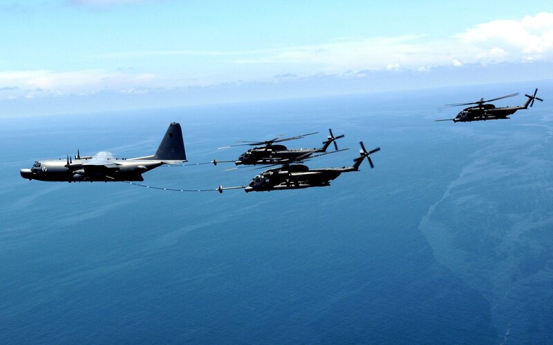 Military aircraft refueling over ocean