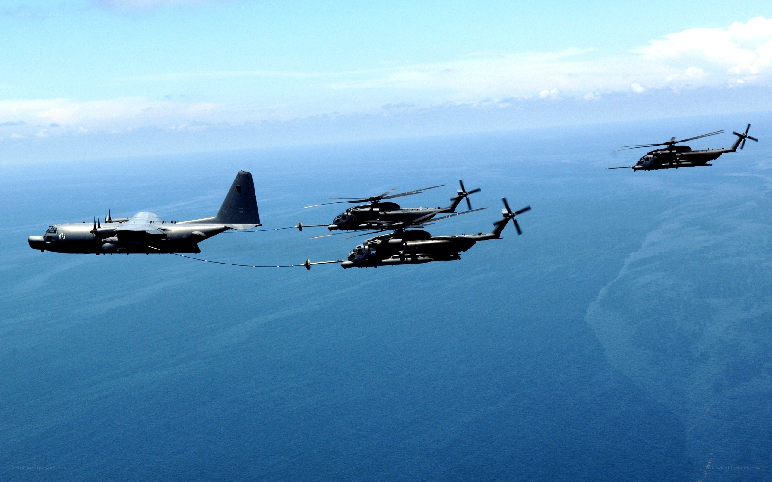 Military aircraft refueling over ocean