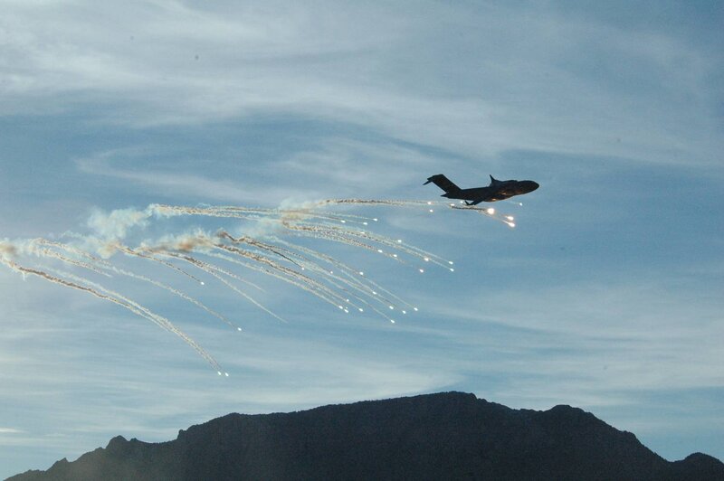 Military Aircraft Releasing Flares — Blue