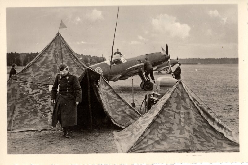 Military airfield with tents and plane