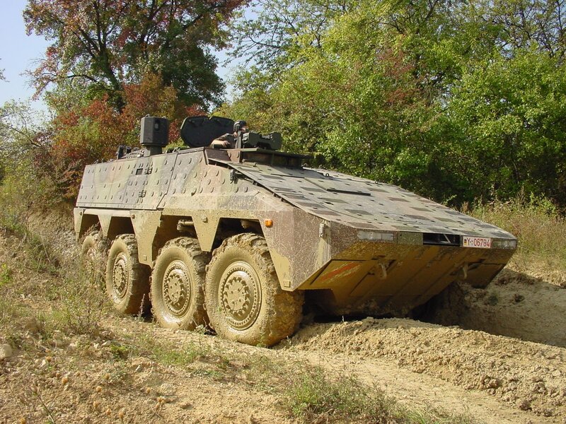 Military armored vehicle on dirt path