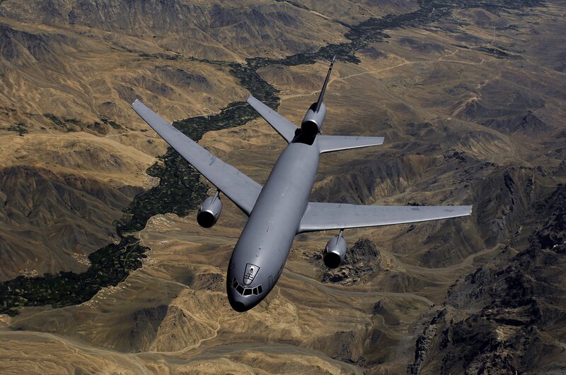 military cargo plane over mountains