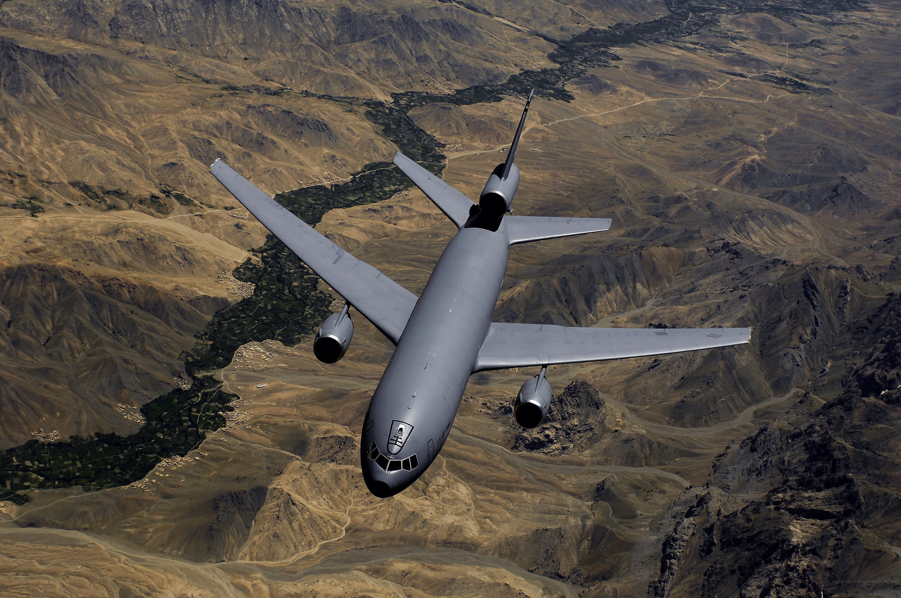 military cargo plane over mountains
