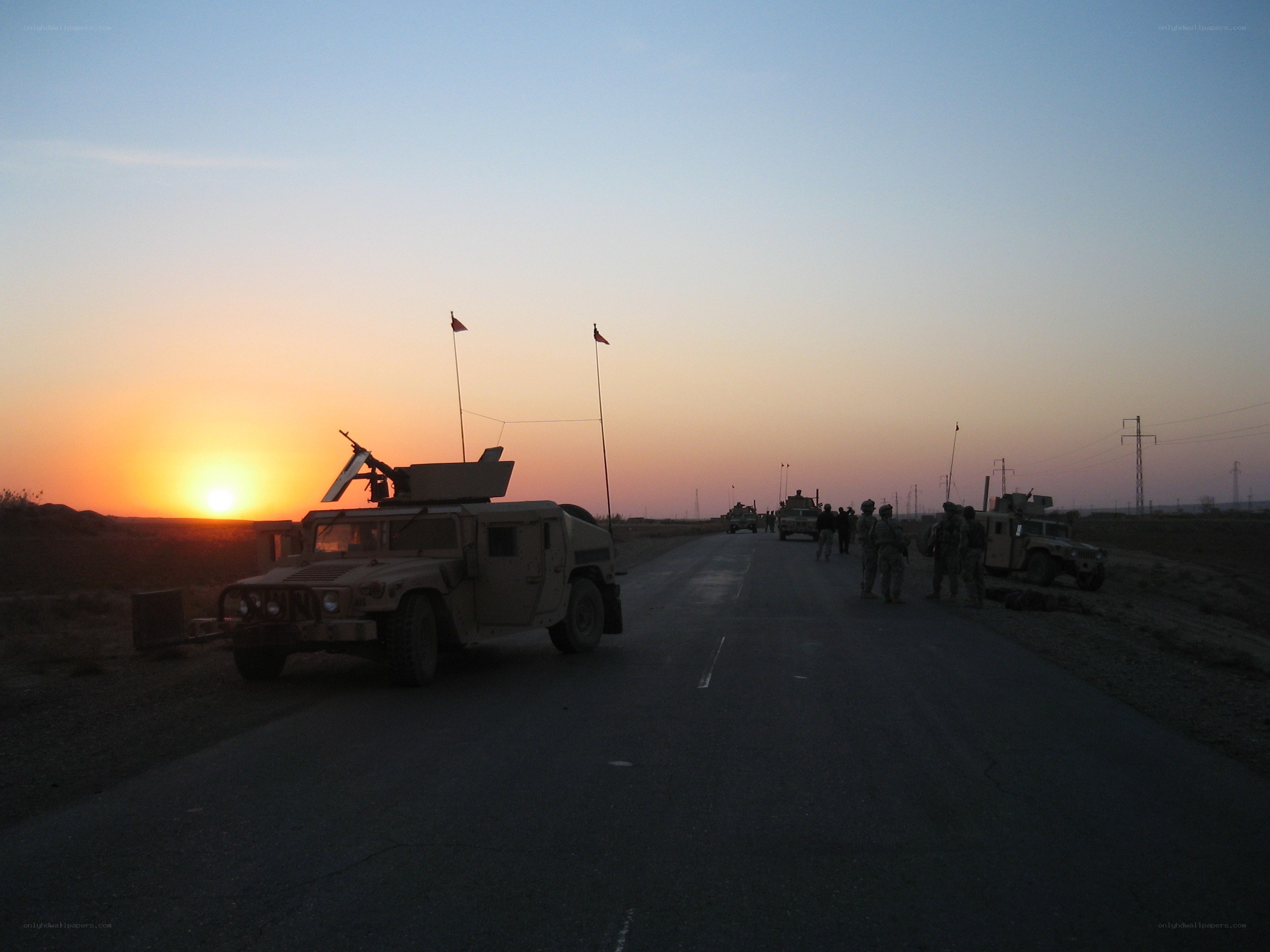Military convoy at sunset
