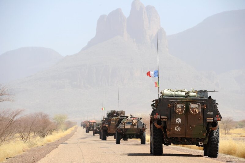 Military convoy in desert landscape