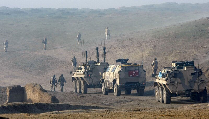 Military convoy in desert terrain