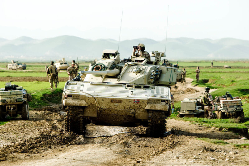 Military convoy in muddy field