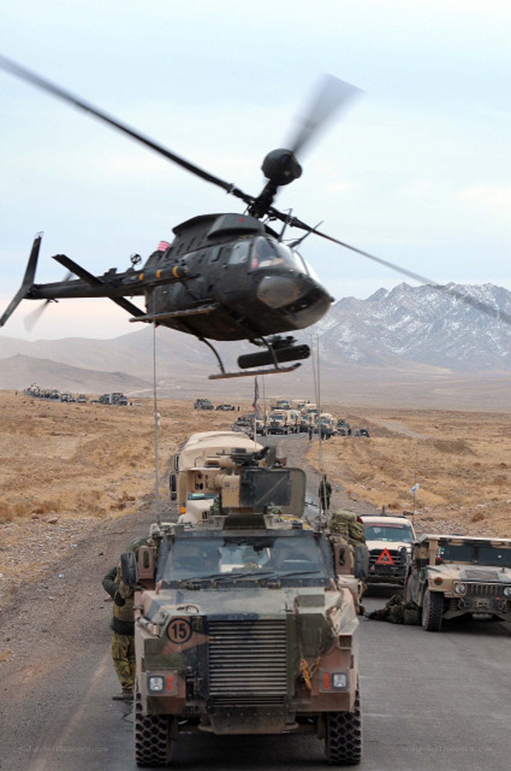 Military convoy with helicopter