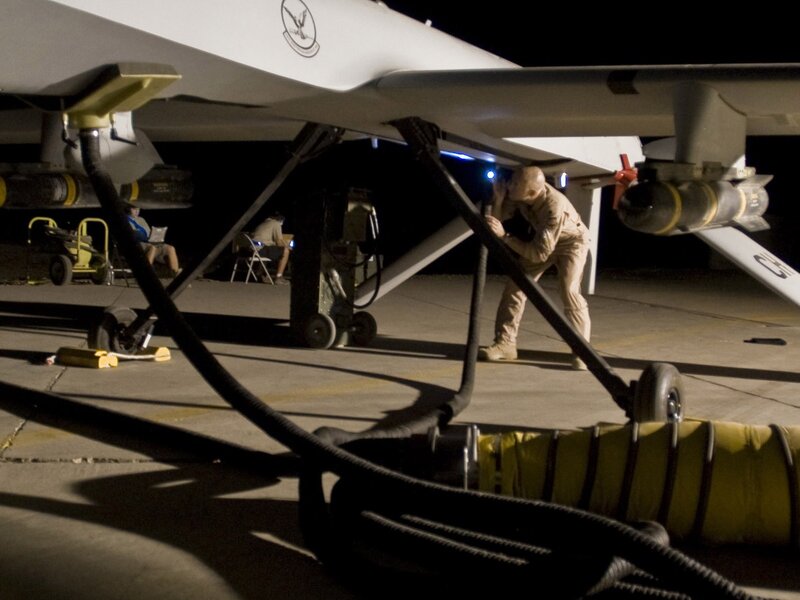 Military drone maintenance at night