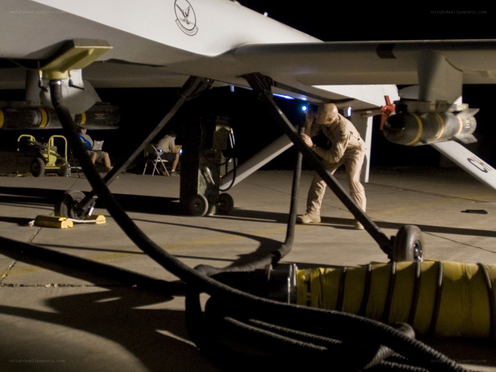 Military drone maintenance at night