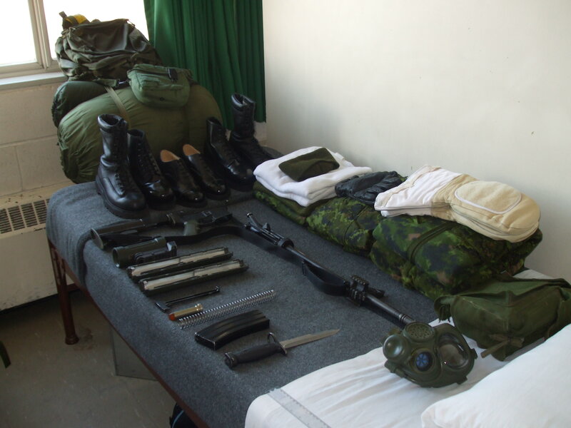 Military gear laid out on a bed