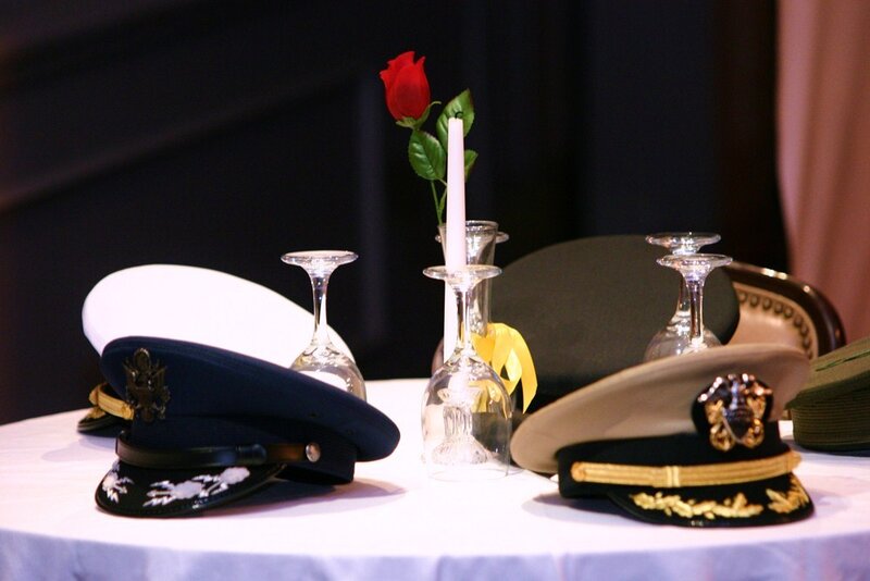 Military hats and rose centerpiece