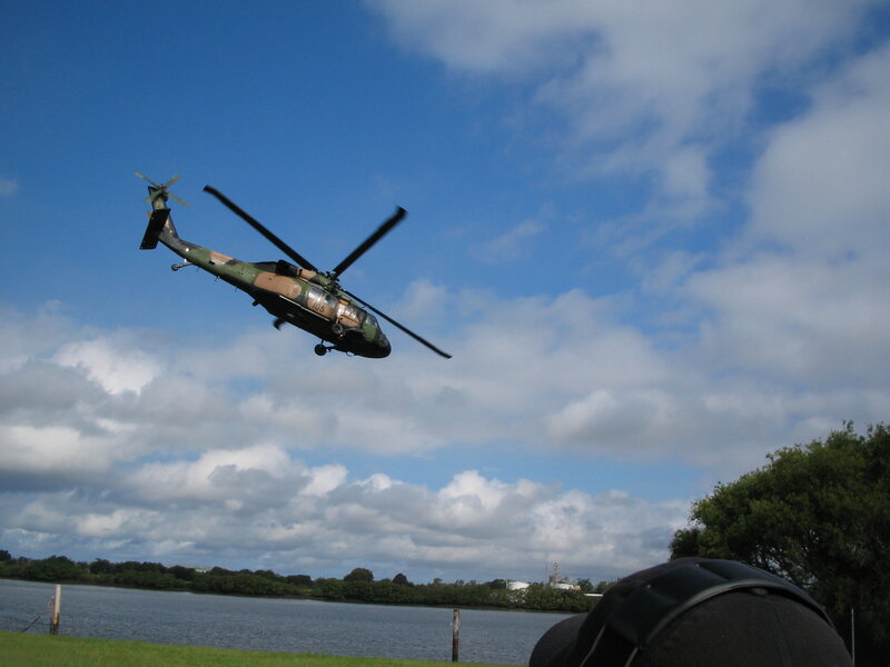 Military helicopter flying over water