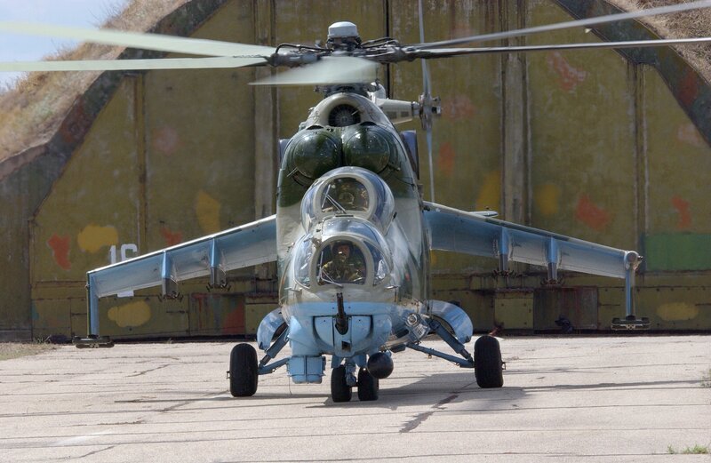 Military Helicopter — Green, Neutral, Afternoon, Photograph, Hangar, Pavement