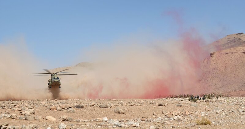 Military helicopter in desert terrain