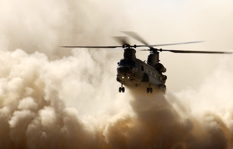 Military helicopter in dust storm