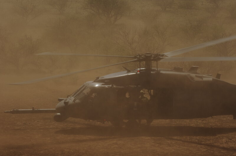 Military helicopter in dusty environment
