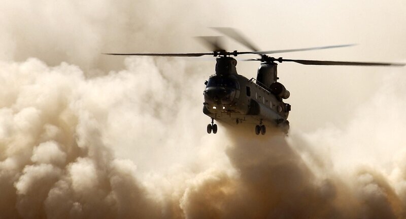Military helicopter in dusty environment