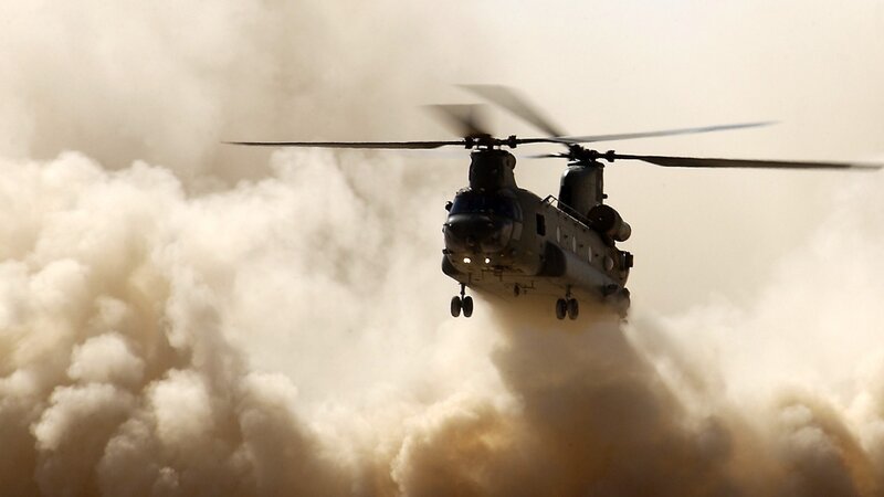 Military helicopter in dusty environment