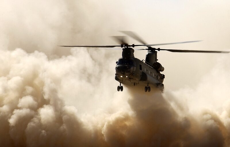 Military helicopter in dusty environment