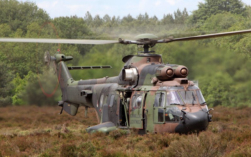 Military helicopter in field