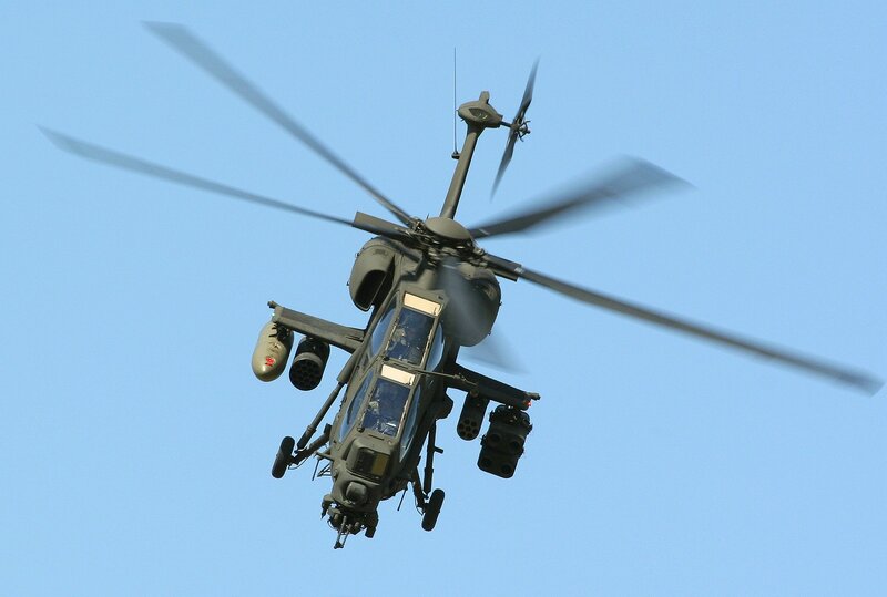 Military Helicopter in Flight — Blue, Dynamic, Afternoon, Photograph, Rotor Blades, Weapons