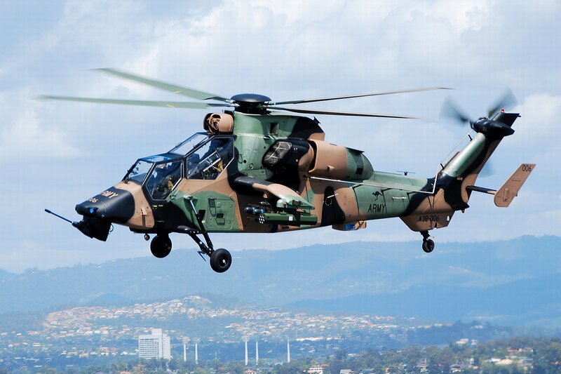 Military Helicopter in Flight — Green, Dynamic, Afternoon, Photograph, City