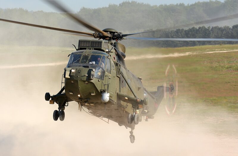 Military Helicopter in Flight — Green, Dynamic, Afternoon, Photograph, Dust