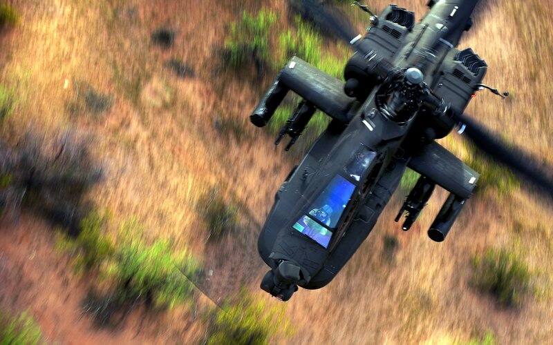 Military Helicopter in Flight — Green, Dynamic, Afternoon, Photograph, Rotor Blades, Weapons